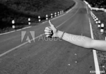 Woman hitchhiking on the street side