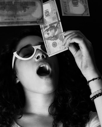 Woman Holding 100 US Dollar Banknote With her Mouth Open