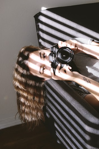 Woman Holding a Black Dslr Camera