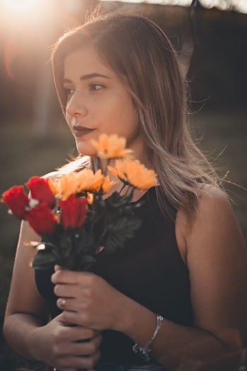 Woman Holding a Bouquet of Flowers Looking Away