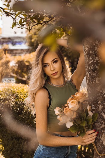 Woman Holding a Bouquet of Yellow Roses