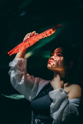 Woman Holding A Fan