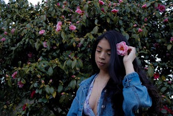 Woman Holding A Flower On Her Hair