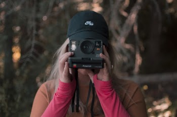 Woman Holding A Polaroid Camera