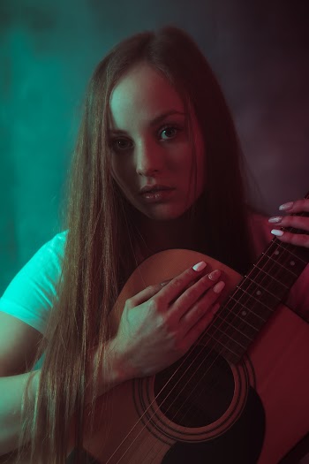 Woman Holding Acoustic Guitar