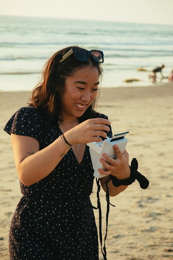 Woman Holding an Instant Camera