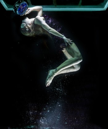 Woman Holding Analog Clock While Swimming Under Body of Water