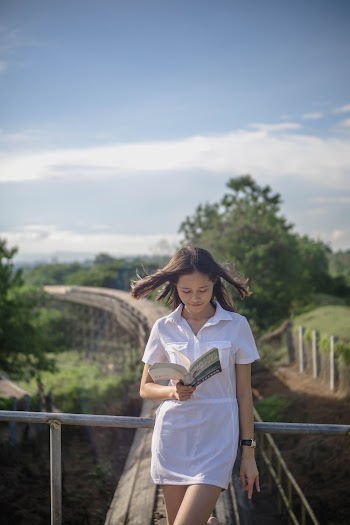 Woman Holding and Reading a Book