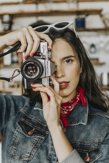 Woman Holding and Using a Camera