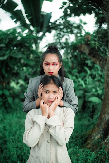 Woman Holding Another Woman's Head