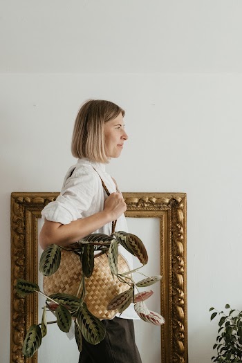 Woman Holding Bag Standing Near Wall