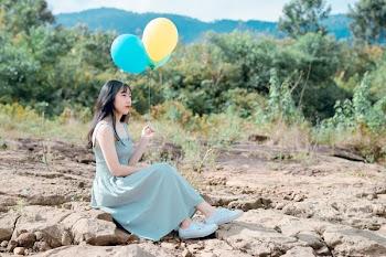 Woman Holding Balloons 