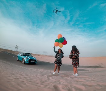Woman Holding Balloons Outdoors