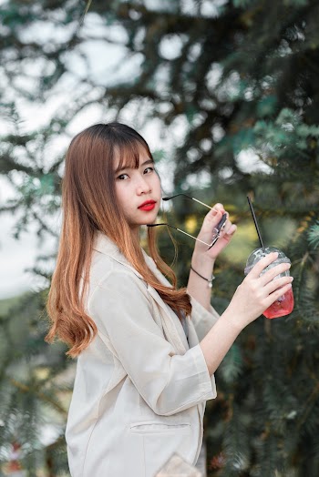 Woman Holding Beverage And Sunglasses