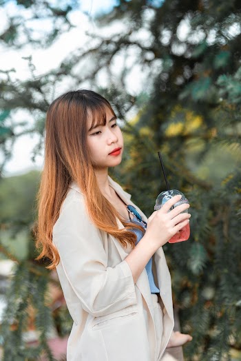 Woman Holding Beverage in Disposable Cup