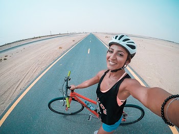 Woman Holding Bicycle on Asphalt Road