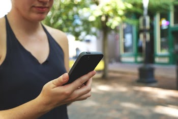 Woman Holding Black Android Smartphone
