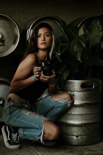 Woman Holding Black Camera