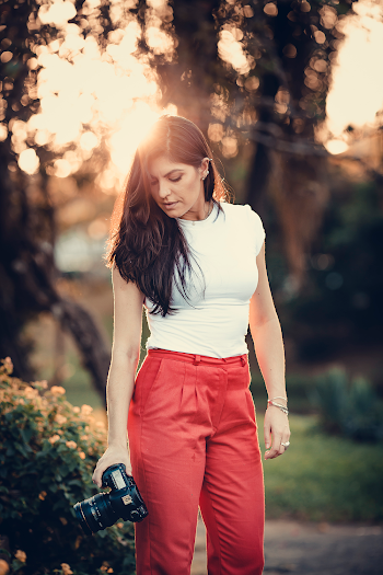 Woman Holding Black Camera on Garden