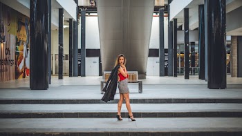 Woman Holding Black Coat on Stair