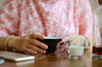Woman Holding Black Cup