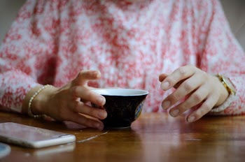 Woman Holding Black Cup