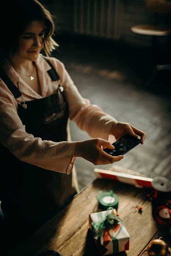Woman Holding Black Device
