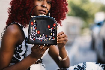 Woman Holding Black Leather Handbag