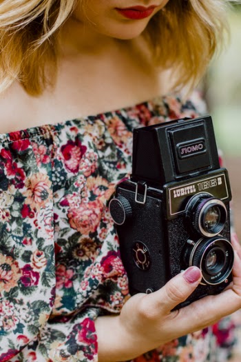 Woman Holding Black Nomo Vintage Camera