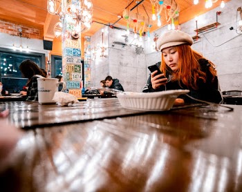 Woman Holding Black Smartphone