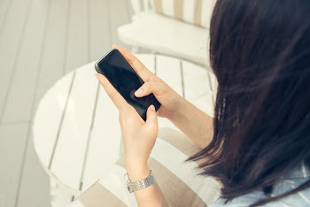Woman Holding Black Smartphone