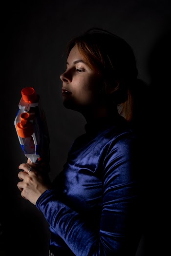 Woman Holding Blue and White Nerf Gun