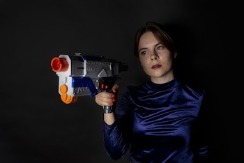 Woman Holding Blue and White Nerf Gun