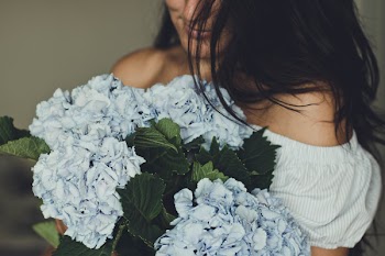 Woman Holding Blue Flowers