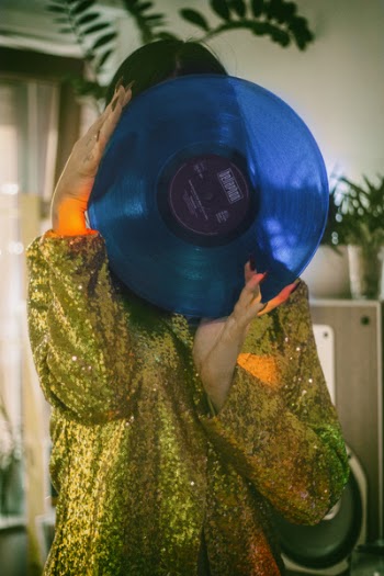 Woman Holding Blue Vinyl Record