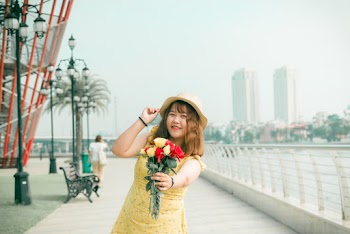 Woman Holding Bouquet of Flowers