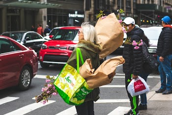 Woman Holding Bouquet Of Flowers Standing By The Road