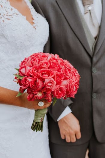 woman holding bouquet of red roses