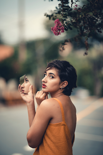 Woman Holding Broken Mirror 