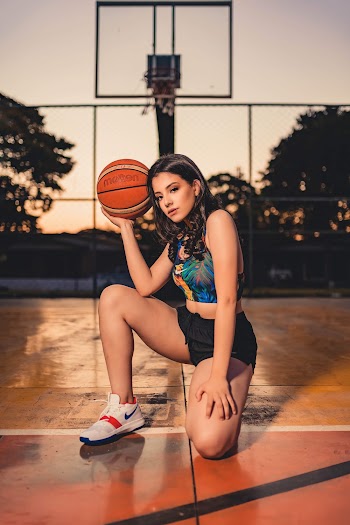 Woman Holding Brown Basketball