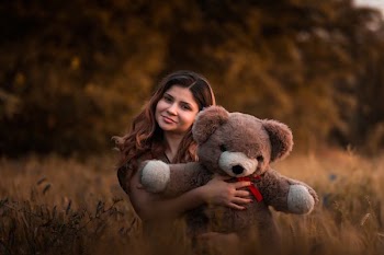 woman holding brown bear