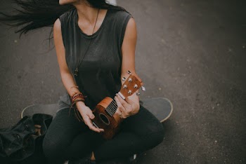 Woman Holding Brown Guitar