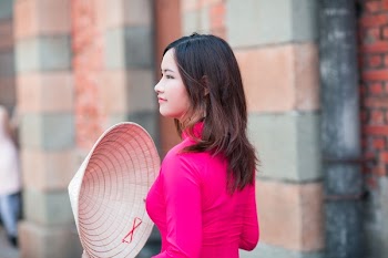 Woman Holding Brown Straw Hat