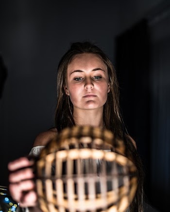Woman Holding Brown Wooden Ball Inside Deemed Room