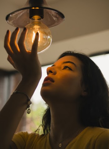 Woman Holding Bulb