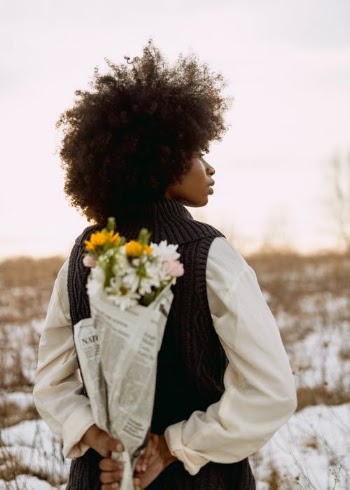 Woman Holding Bunch of Flowers Behind Back  · Free Stock Photo
