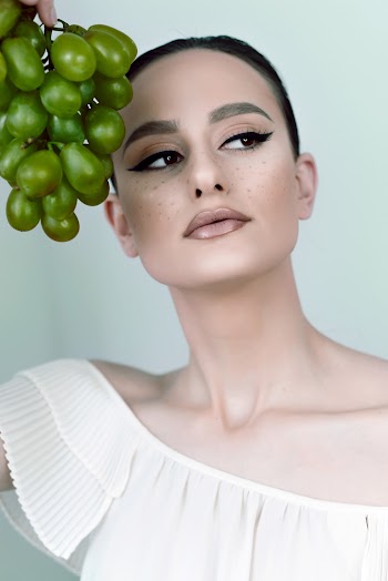 Woman Holding Bunch Of Grapes