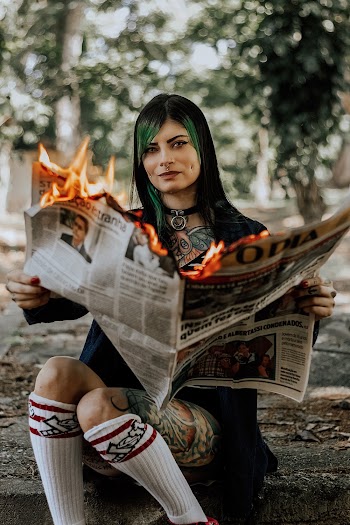 Woman Holding Burning Newspaper