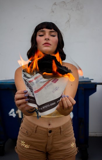 Woman Holding Burning Paper