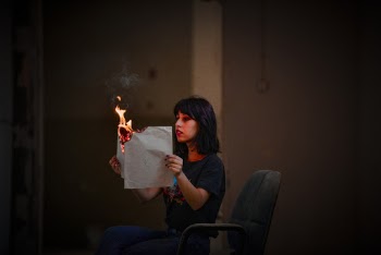 Woman Holding Burning Paper